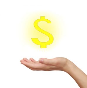 Woman hand holding yellow dollar sign isolated on white. Busines