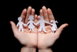 Paper chain family protected in cupped hands